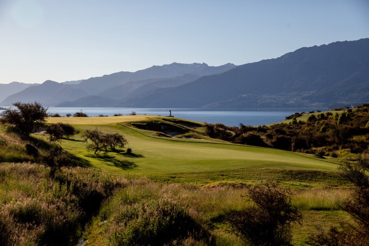 A fairway at Jacks Point falling away towards Lake Wakatipu, with the Remarkables behind.