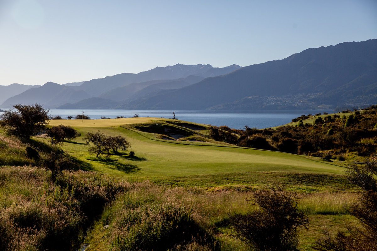 A fairway at Jacks Point falling away towards Lake Wakatipu, with the Remarkables behind.