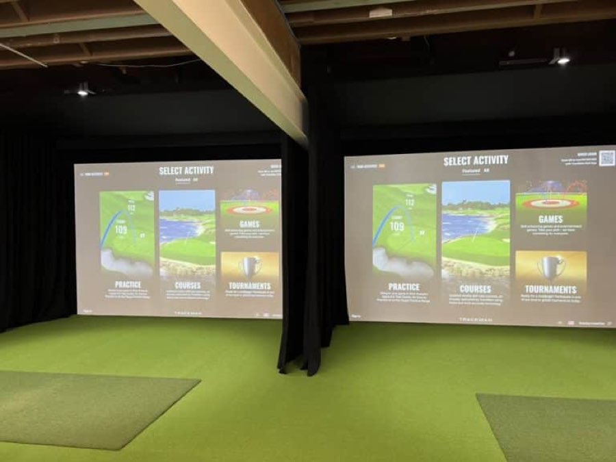 Two indoor hitting bays at Prime Golf, each with a full-width projected simulator screen.